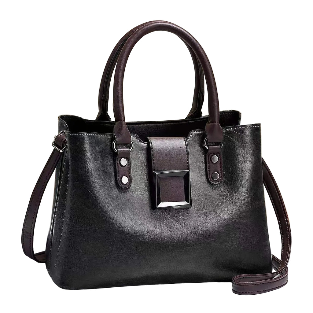 Black handbag with brown accents on a light surface with a beige background