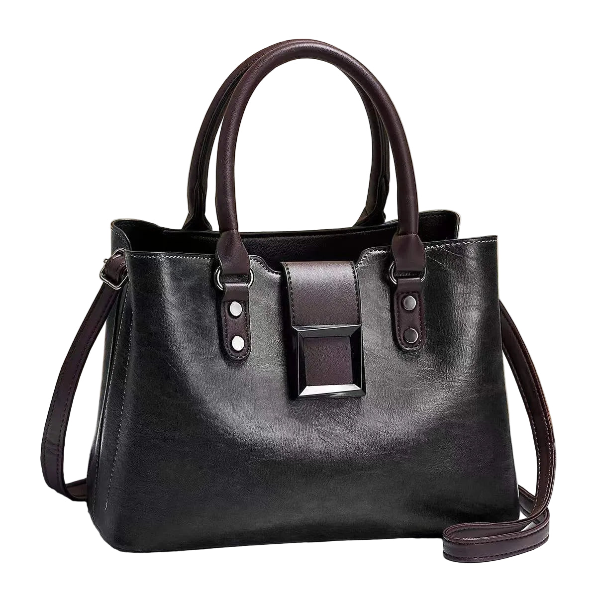 Black handbag with brown accents on a light surface with a beige background