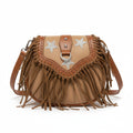 Brown leather handbag with star designs and fringe on a newspaper background
