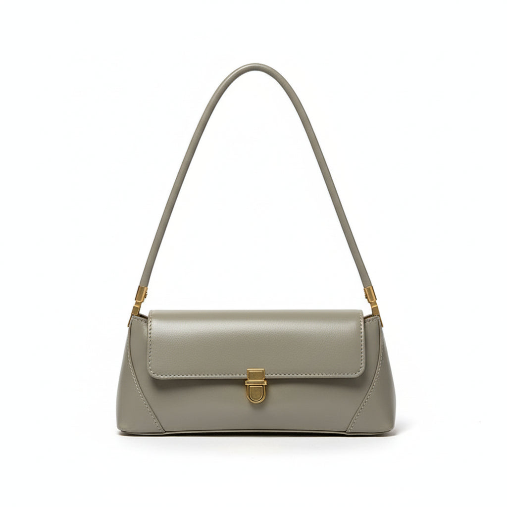 Green handbag hanging on a door handle against a white wall.