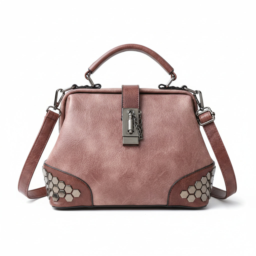 Pink handbag with hexagonal pattern on a wooden surface