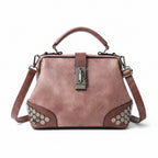 Pink handbag with hexagonal pattern on a wooden surface
