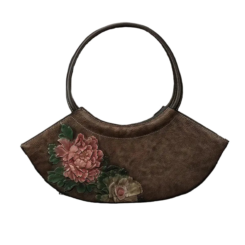 Brown handbag with floral embroidery on a textured brown background