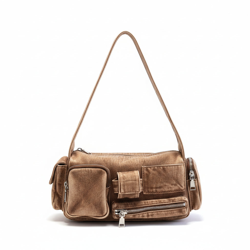 Brown denim handbag on a white surface with a striped garment in the background