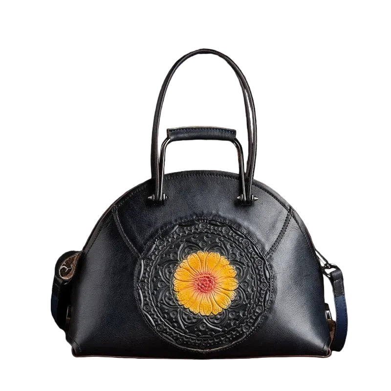 Black handbag with a yellow flower design on a brown background