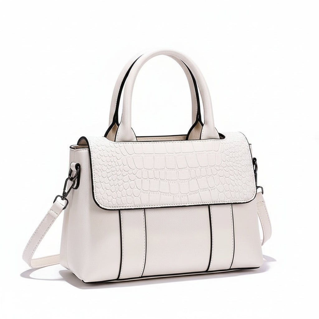 White handbag with a textured pattern on a white surface with a brown background