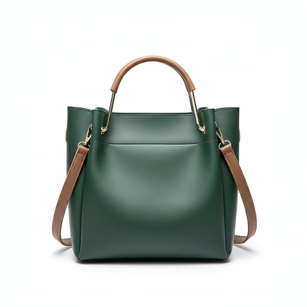 Green handbag with brown handle and strap on a wooden surface