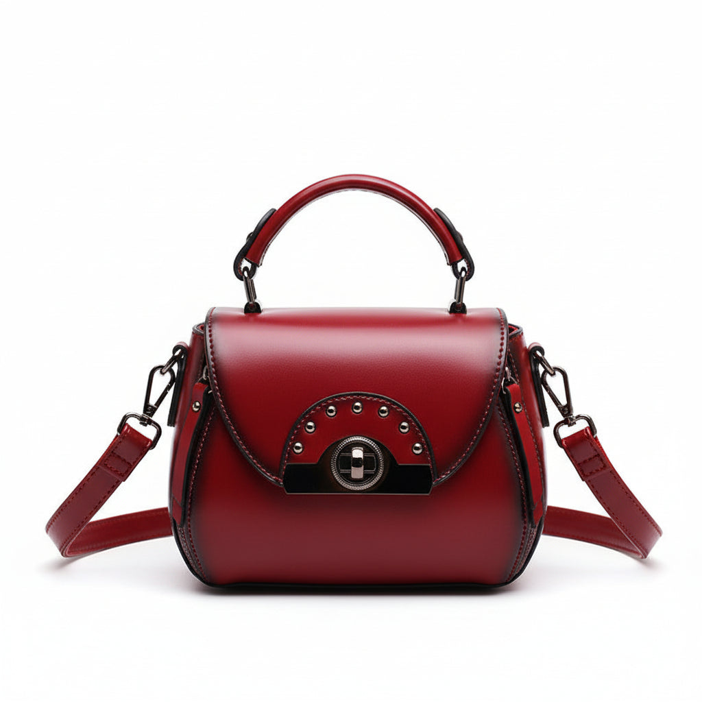 Red handbag with studded detail on a wooden stand labeled 'ORIGINALS' against a brown background