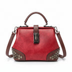 Red handbag with brown accents on a wooden surface