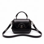 Black handbag with a strap on a wooden surface with 'ORIGINALS' branding.
