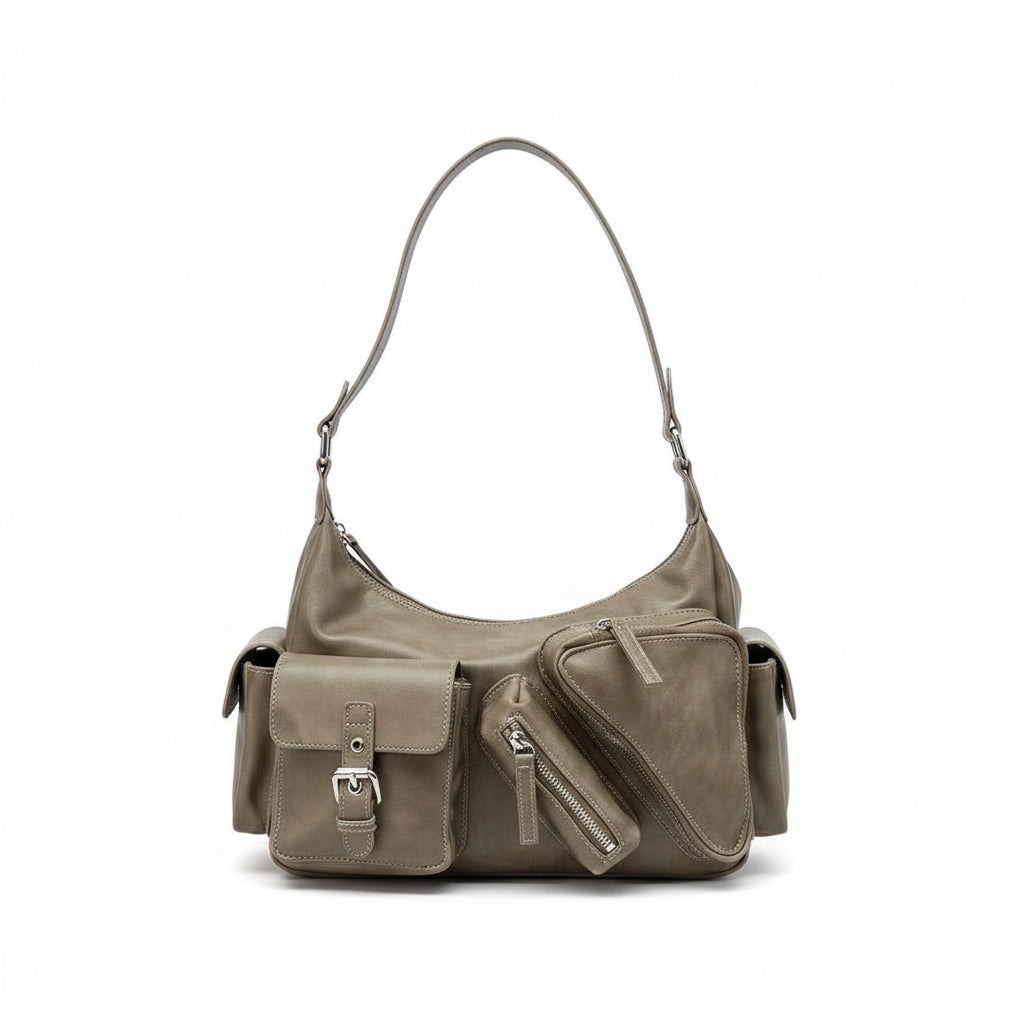 Beige handbag on a laptop on a metal cart with a neutral background