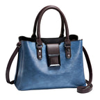 Blue handbag with brown straps on a light background