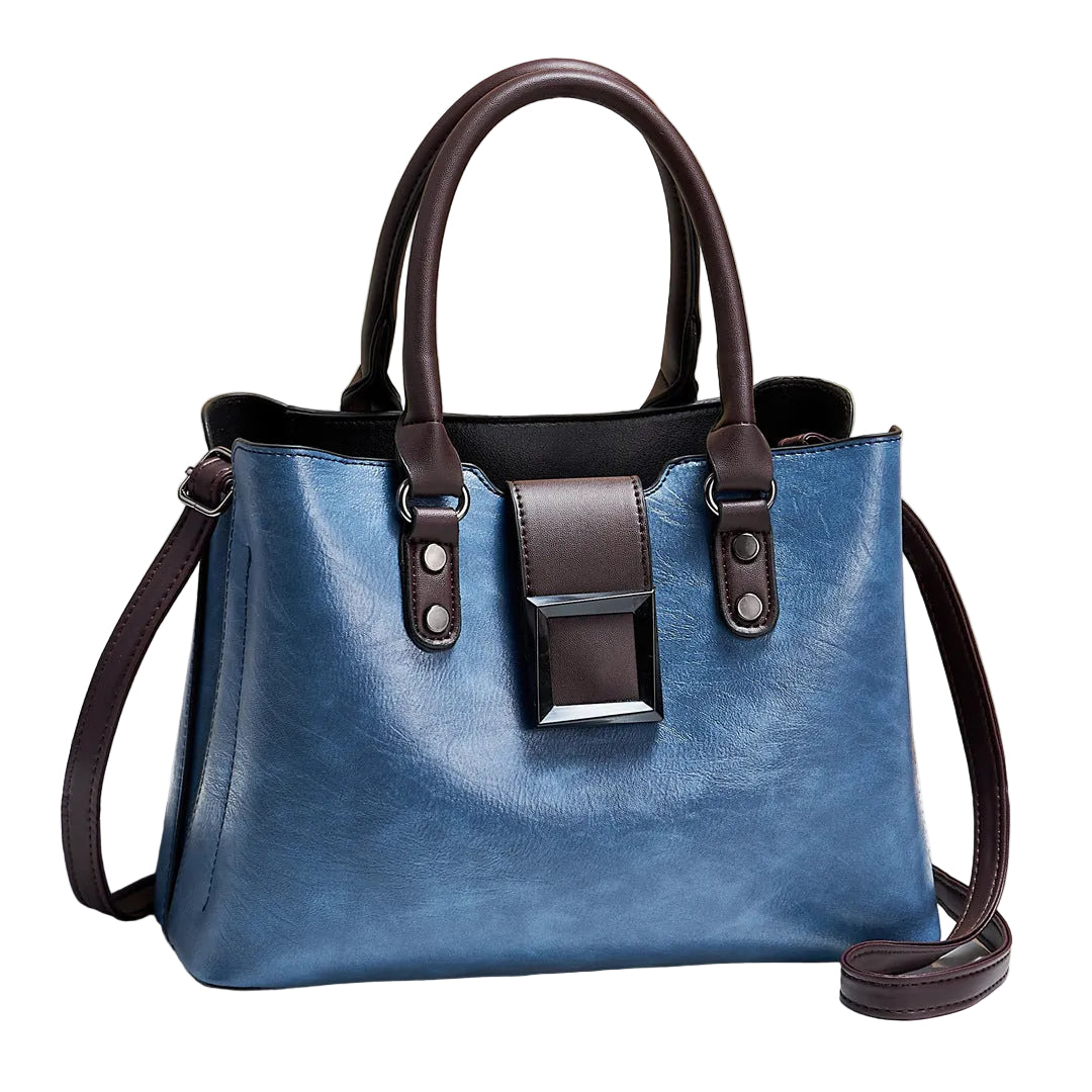 Blue handbag with brown straps on a light background