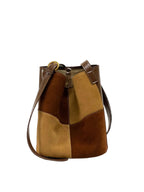 Brown and beige patchwork handbag on a white background