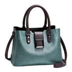 Teal handbag with brown straps on a light background