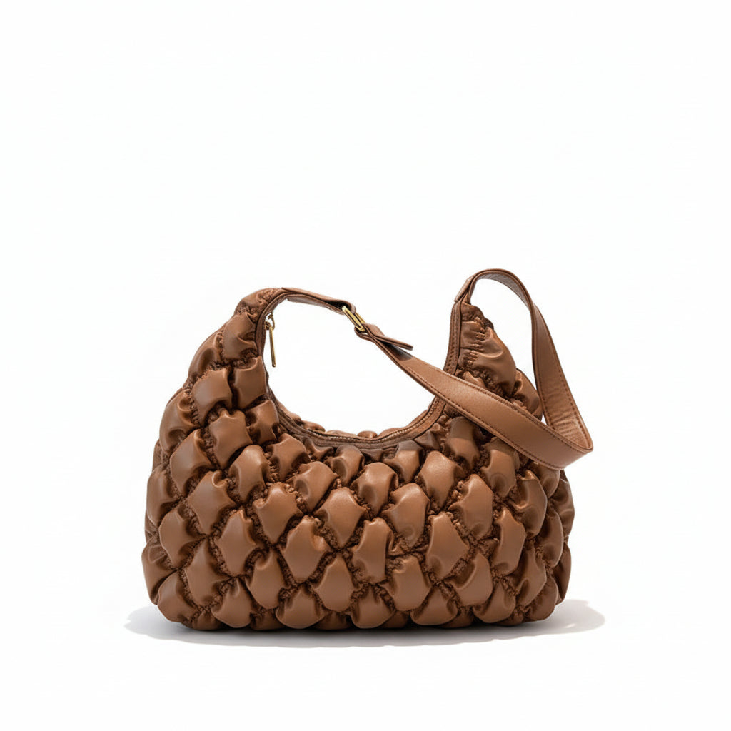 Brown woven handbag on a black surface with a white background