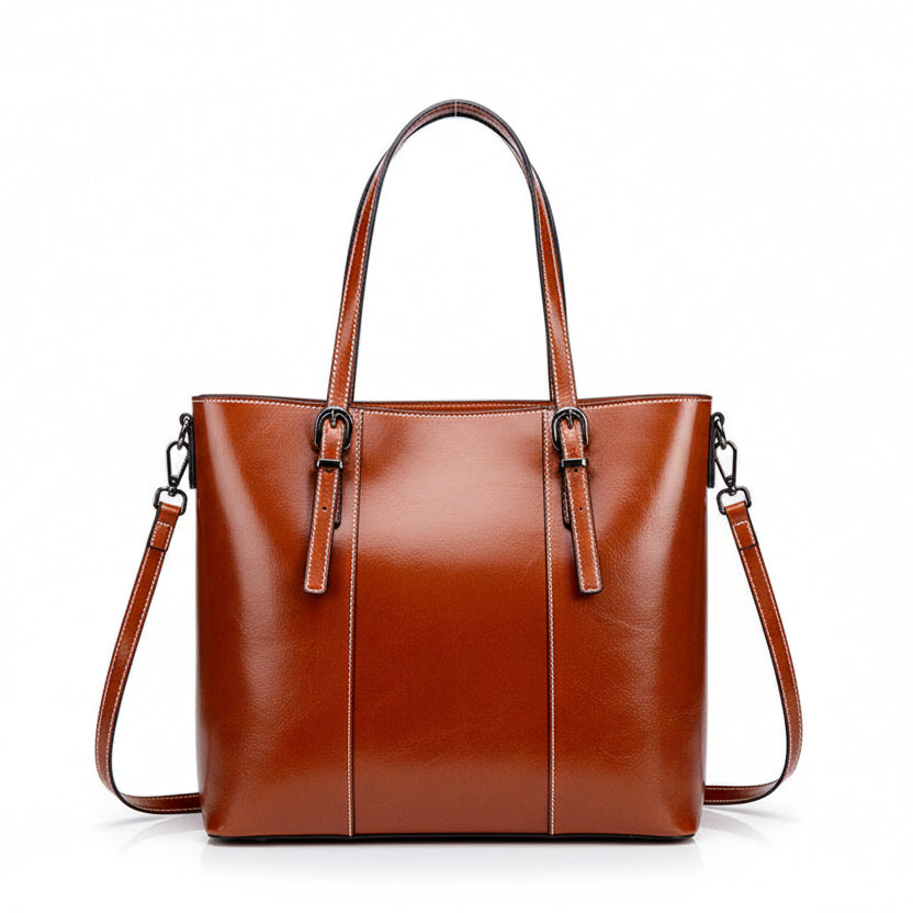 Brown leather handbag on a white surface