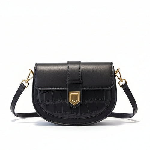 Black handbag with gold hardware on a beige coat