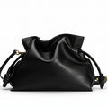 Black drawstring bag on a light gray background