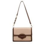 Beige handbag with brown accents on a white background