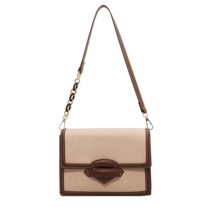 Beige handbag with brown accents on a white background