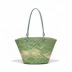 Green woven handbag on a hanger against a white background
