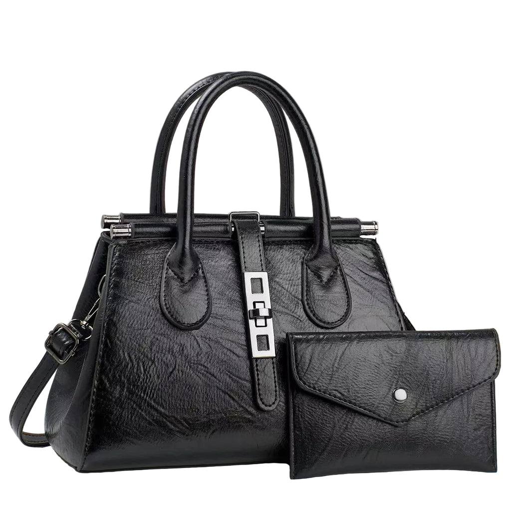 Black handbag with matching wallet on a light gray background