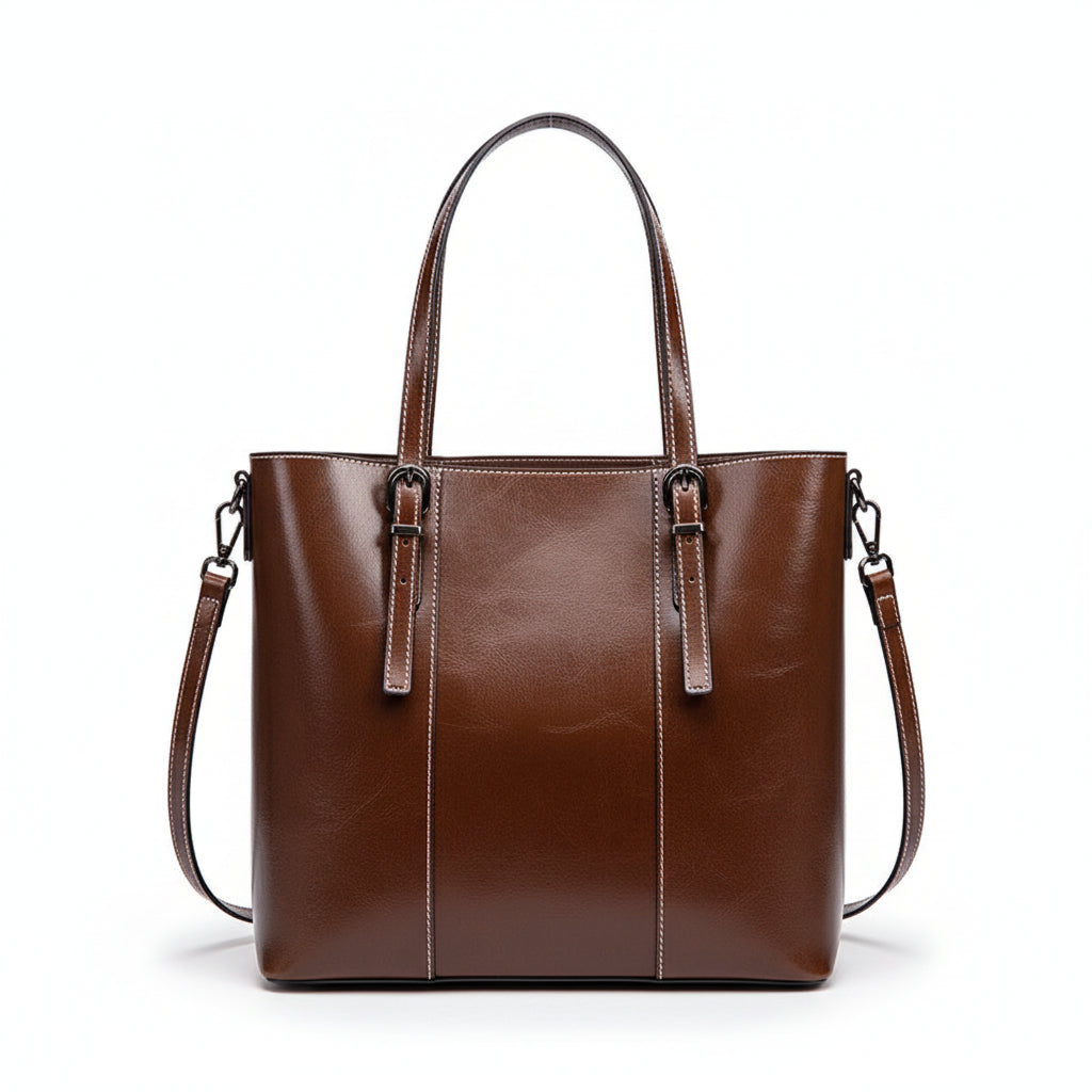 Brown leather handbag on a white cushion with a light gray background