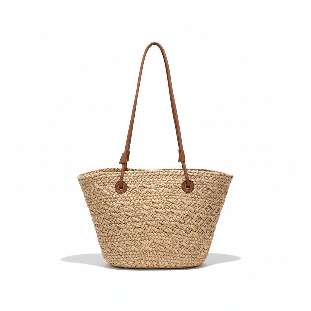 Woven beige handbag with brown straps on a hanger against a clothing store background.